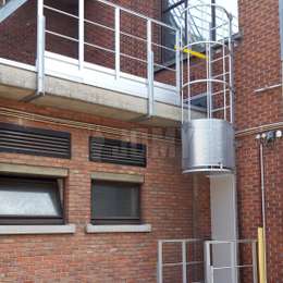 Secured roof access ladder for maintenance Roof ladder with cage, security door, gate and guardrails used for maintenance.